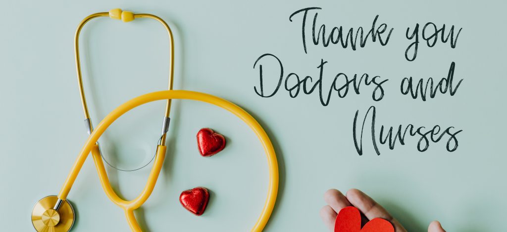 A yellow stethoscope, three red heart-shaped objects, and a hand holding a red heart are displayed against a light blue background. The text 